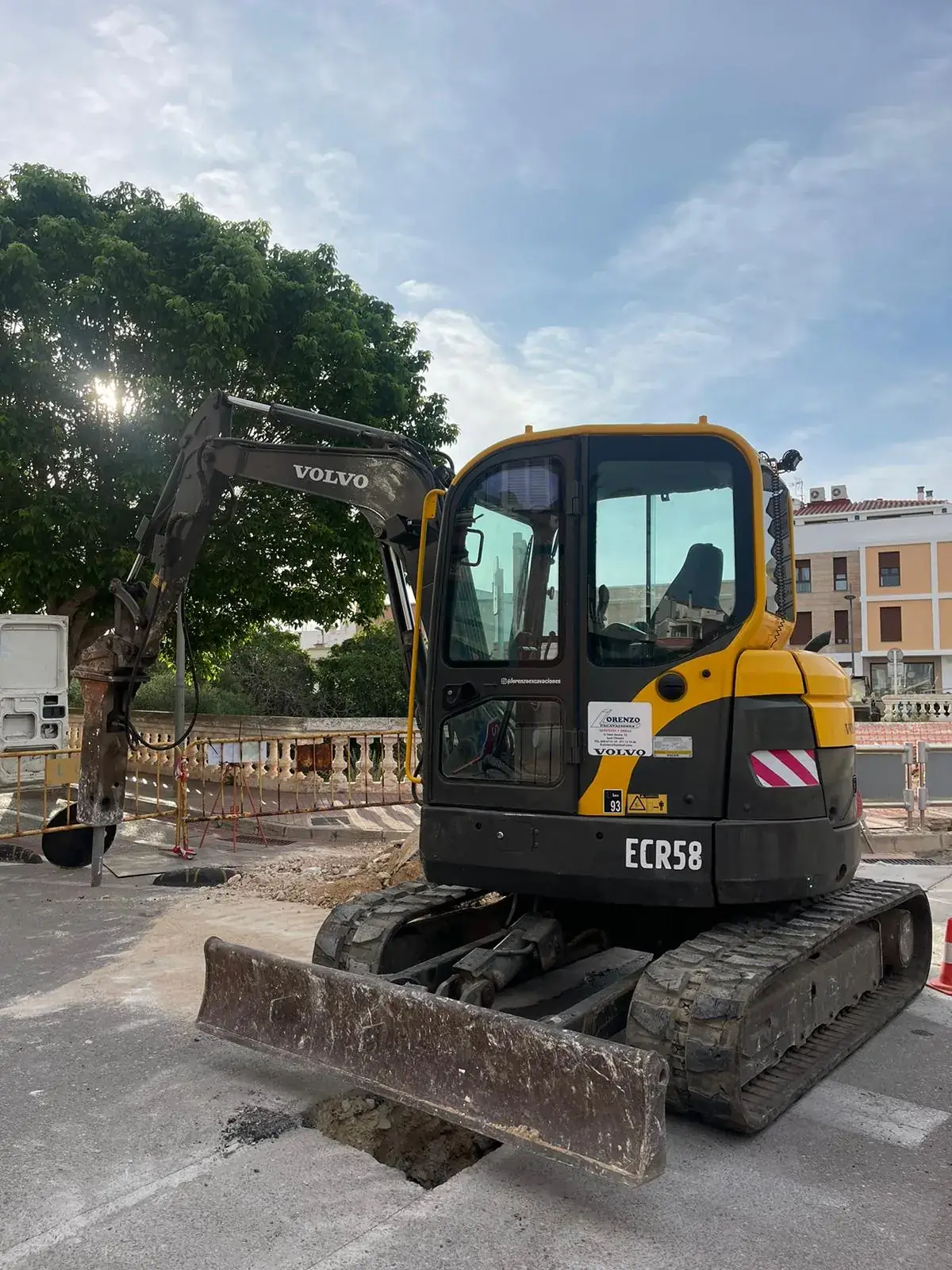 Volvo ECR58 short-swing mini-excavator with hydraulic hammer on an urban job